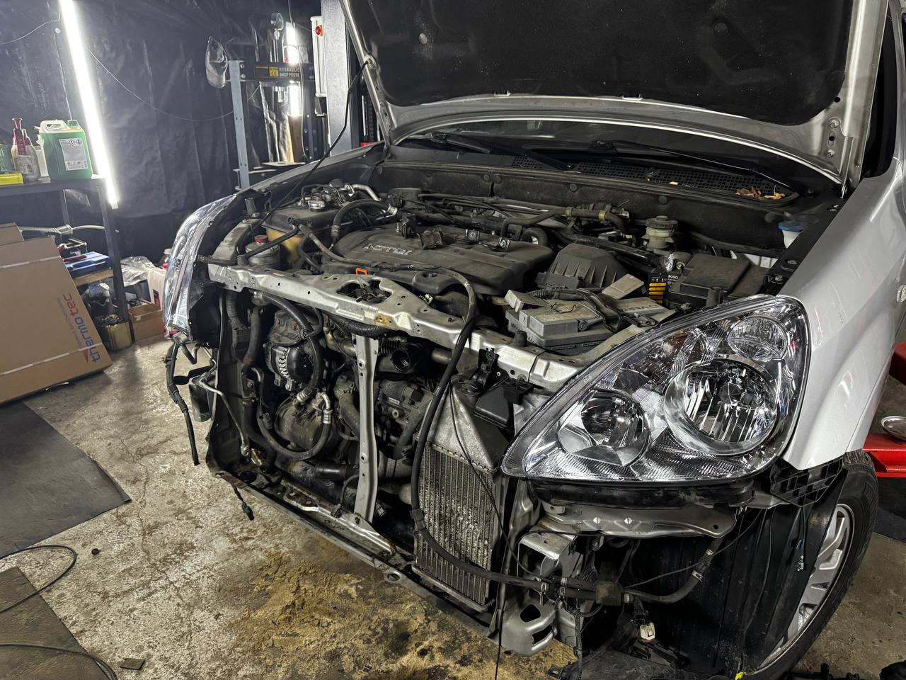 Vehicle with front bumper removed during repair at VelaroAuto