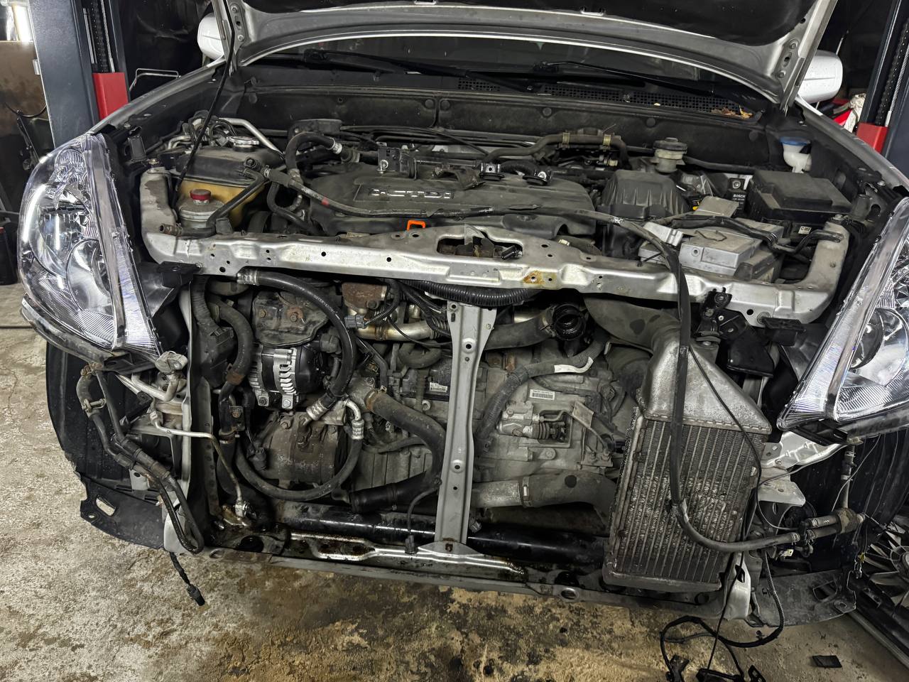 Engine bay and cooling system during repair at VelaroAuto